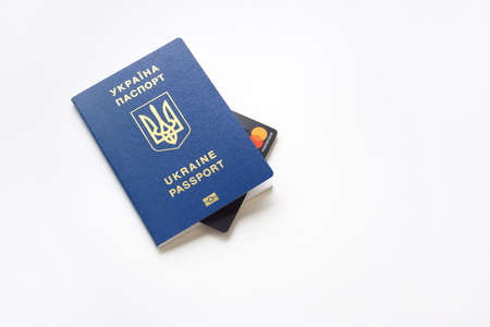 Kharkiv, Ukraine - November 5, 2021: Mastercard credit card in Ukrainian passport. The concept of cashless payment for travel services and not only.のeditorial素材