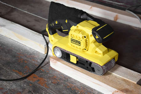 Kharkiv, Ukraine - October 6, 2021: Sanding machine yellow-black for working with wood from Stanley.のeditorial素材
