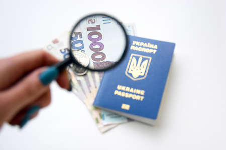 New banknotes in denominations of 500 and 1000 hryvnia with a Ukrainian passport.の写真素材