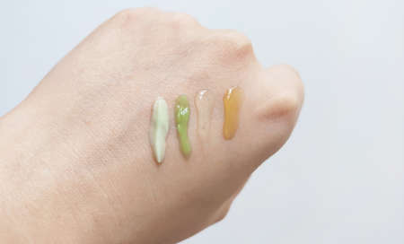 A few dabs of cream on the hand of a young girl. The concept of cosmetology and skin health.の写真素材