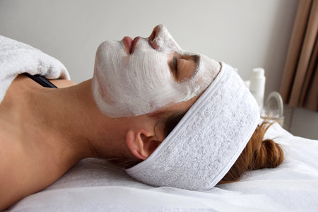 Face mask on a young girl, beauticians office.の写真素材