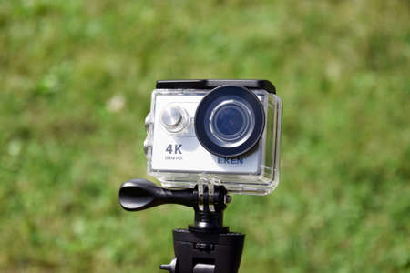 KHARKIV, UKRAINE - SEPTEMBER 4, 2021: Action camera Eken H9 Ultra HD on the background of grass.