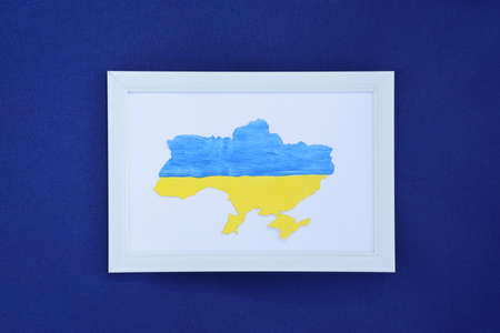 Outline of the country Ukraine, decorated in blue and yellow colors, like the national flag of Ukraine. Independence, flag, Constitution Day. War in Ukraine.の写真素材