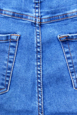 Flat lay, denim jeans leg seam detail, background texture. Copy space.