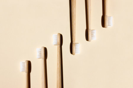 Bamboo toothbrushes on light background. Say no to plastic concept. Top view, copy space, flat lay.