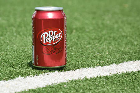 Kharkiv, Ukraine - June 1, 2022: A metal can of Dr. Pepper stands against a background of green...