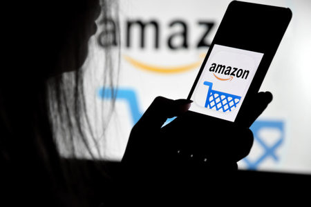 Kharkiv, Ukraine - December 20, 2021: A phone with a Amazon screen in the hands of a young girl...