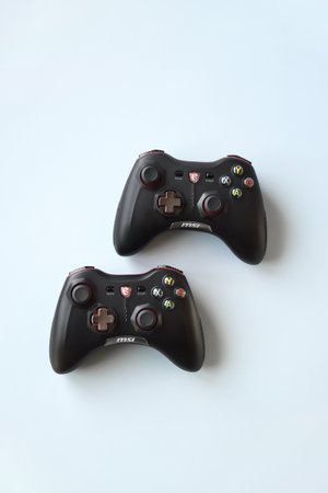 Kharkiv, Ukraine - February 21, 2022: Two MSI joystick gaming controller on light blue background....