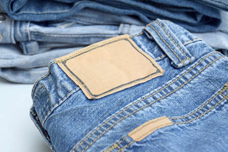 Folded jeans on a light blue background.の写真素材