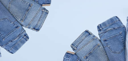 Lots of jeans pants in a stack. Denim background.の写真素材