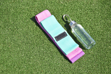 Multi-colored fabric elastic bands for fitness on the grass. Sports, fitness, pilates, stretching.の写真素材
