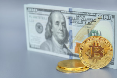 Kharkiv, Ukraine - October 7, 2022: US Dollar and Digital money Bitcoin coin Put together. Concept of digital money is becoming a competitor in major currencies such as the dollar.のeditorial素材