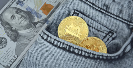 Kharkiv, Ukraine - October 7, 2022: US Dollar and Digital money Bitcoin coin Put together. Concept of digital money is becoming a competitor in major currencies such as the dollar.のeditorial素材