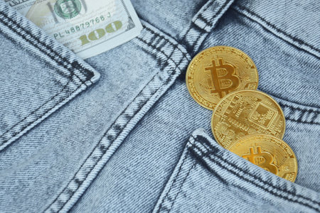 Kharkiv, Ukraine - October 7, 2022: US Dollar and Digital money Bitcoin coin Put together. Concept...