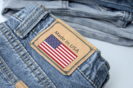Folded jeans and the inscription Made in USA on the label. The concept of buying, selling, shopping...