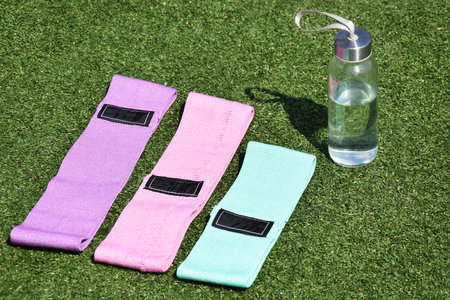 Multi-colored fabric elastic bands for fitness on the grass. Sports, fitness, pilates, stretching.