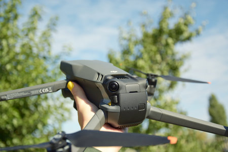 Kharkiv, Ukraine - September 12, 2022: A new DJI Mavic 3 drone on blue sky background.のeditorial素材