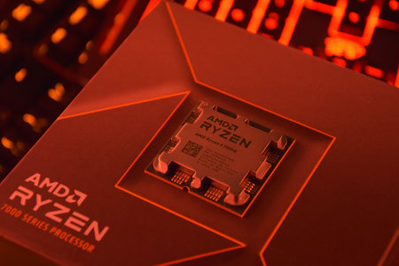 UKRAINE, KHARKIV, NOVEMBER 14, 2022: A close-up of an AMD Ryzen 9 3900X processor in a packaging box with backlit keyboards in the background.のeditorial素材
