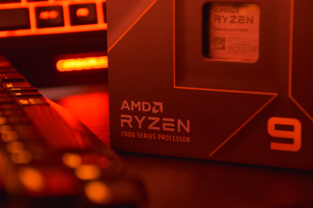 UKRAINE, KHARKIV, NOVEMBER 14, 2022: A close-up of an AMD Ryzen 9 3900X processor in a packaging box with backlit keyboards in the background.のeditorial素材