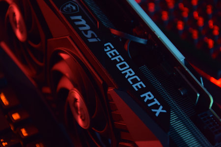 UKRAINE, KHARKIV, NOVEMBER 14, 2022: MSI Geforce RTX 3090 Ti gaming X TRIO graphics card, dark background. Hardware components for build PC or mining rig.のeditorial素材
