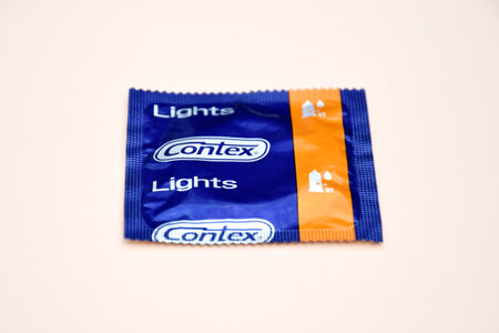 KHARKIV, UKRAINE - OCTOBER 16, 2021: Contex condom on ivory background. Contex is a brand of condoms...