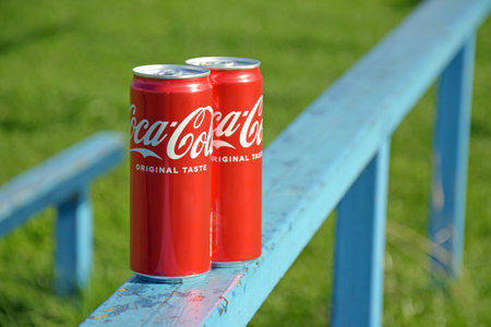 Kharkiv, Ukraine - September 18, 2022: Two cans of Coca-Cola soda. Coca-Cola is a world famous non-alcoholic carbonated drink produced by the Coca-Cola Company.のeditorial素材