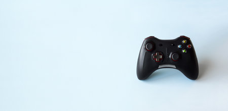 Two joystick gaming controller on light blue background. Minimalism.の写真素材