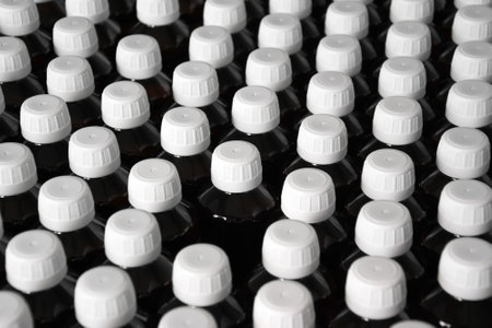 Production line conveyor with plastic bottles in a factory.の写真素材