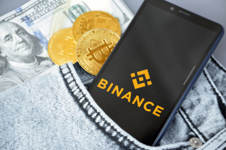 Binance on smartphone screen with bitcoin cryptocurrency.のeditorial素材
