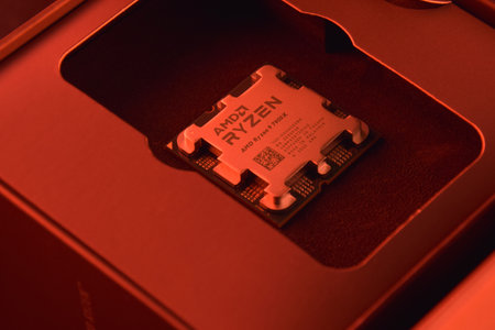 UKRAINE, KHARKIV, NOVEMBER 14, 2022: A close-up of an AMD Ryzen 9 3900X processor in a packaging box with backlit keyboards in the background.のeditorial素材