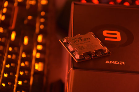 UKRAINE, KHARKIV, NOVEMBER 14, 2022: A close-up of an AMD Ryzen 9 3900X processor in a packaging box with backlit keyboards in the background.のeditorial素材