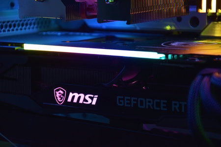 UKRAINE, KHARKIV, NOVEMBER 14, 2022: MSI Geforce RTX 3090 Ti gaming X TRIO graphics card, dark background. Hardware components for build PC or mining rig.のeditorial素材