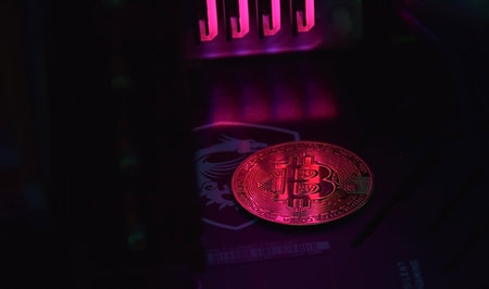 UKRAINE, KHARKIV, NOVEMBER 14, 2022: Bitcoin digital money on a backlit video card. Concept of digital money is becoming a competitor in major currencies such as the dollar.のeditorial素材