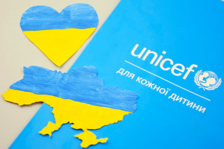 KHARKIV, UKRAINE - FEBRUARY 12, 2023: Unicef logo on the flyer. UNICEF is a United Nations program that provides humanitarian and developmental assistance to children and mothers in developing countries.のeditorial素材