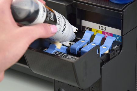 KHARKIV, UKRAINE - FEBRUARY 11, 2023: Ink compartment of the EPSON L3150 printer, Epson T544.のeditorial素材