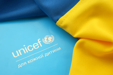 KHARKIV, UKRAINE - FEBRUARY 12, 2023: Unicef logo on the flyer. UNICEF is a United Nations program that provides humanitarian and developmental assistance to children and mothers in developing countries.のeditorial素材