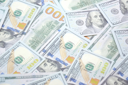 A pile of one hundred US banknotes with president portraits. Cash of hundred dollar bills, dollar...