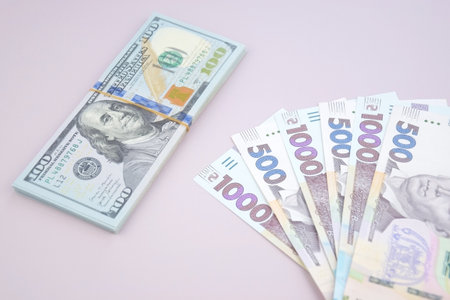 American dollars and Ukrainian hryvnia. The concept of the American aid to Ukraine in the war. The...
