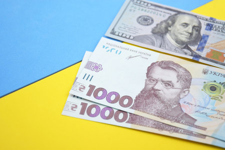 American dollars and Ukrainian hryvnia. The concept of the American aid to Ukraine in the war. The concept of the exchange rate.の写真素材