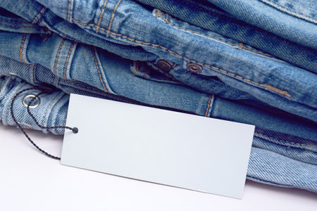 Lots of jeans pants in a stack. Denim background. The concept of buying, selling, shopping and trendy modern clothes.の写真素材