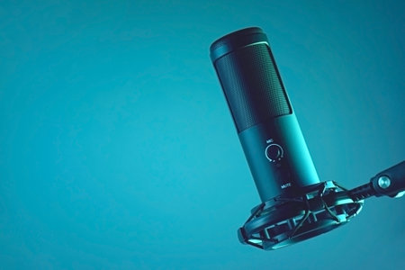 Studio condenser microphone isolated on dark background. The concept of vocals, streaming, podcast.の写真素材
