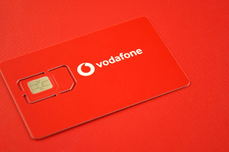 KHARKIV, UKRAINE - FEBRUARY 11, 2023: Vodafone starter pack on a red background.のeditorial素材