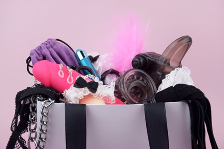 Sex toys in a white package on a light background with copyspace text for a sex shop. The concept of sexual health.の写真素材