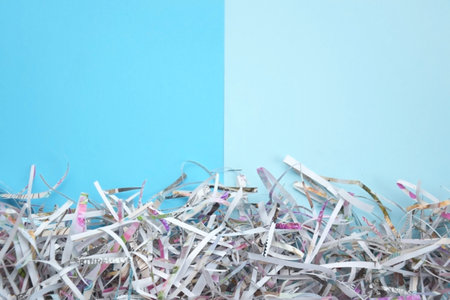 Shredded paper on light blue background. selective focus image.の写真素材
