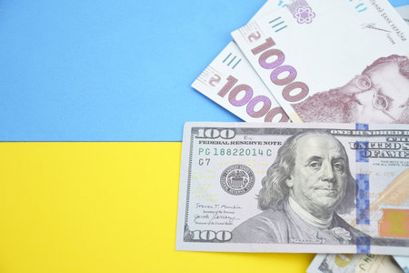 American dollars and Ukrainian hryvnia. The concept of the American aid to Ukraine in the war. The concept of the exchange rate.の写真素材