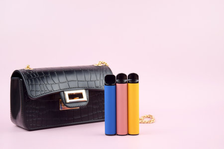 Set of multicolor disposable electronic cigarettes on a pink background. The concept of modern smoking, vaping and nicotine.の写真素材
