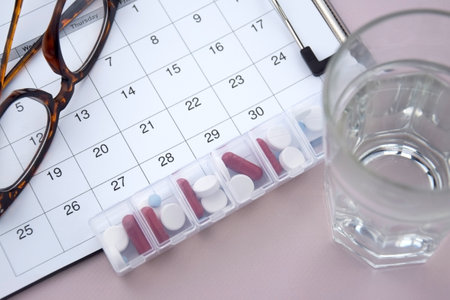 Calendar with pills and non-contact thermometer. The concept of treatment from diseases.の写真素材