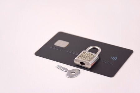 Financial fraud protection concept: credit card, padlock and master key on the light background.の写真素材