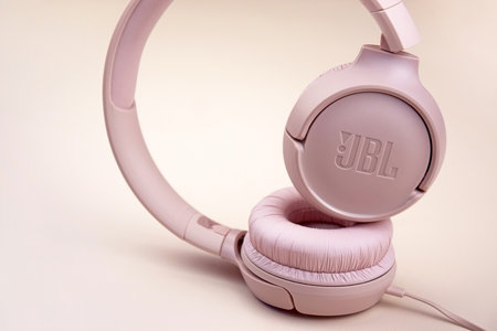 Kharkiv, Ukraine, July 06, 2023: JBL T500 Pink wired headphones with deep bass.