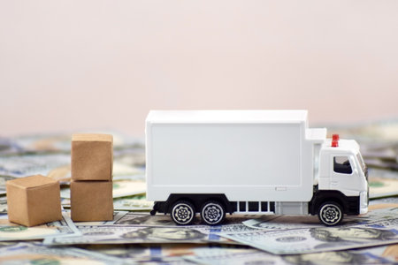 White toy truck with boxes on a light background, space for text.の写真素材